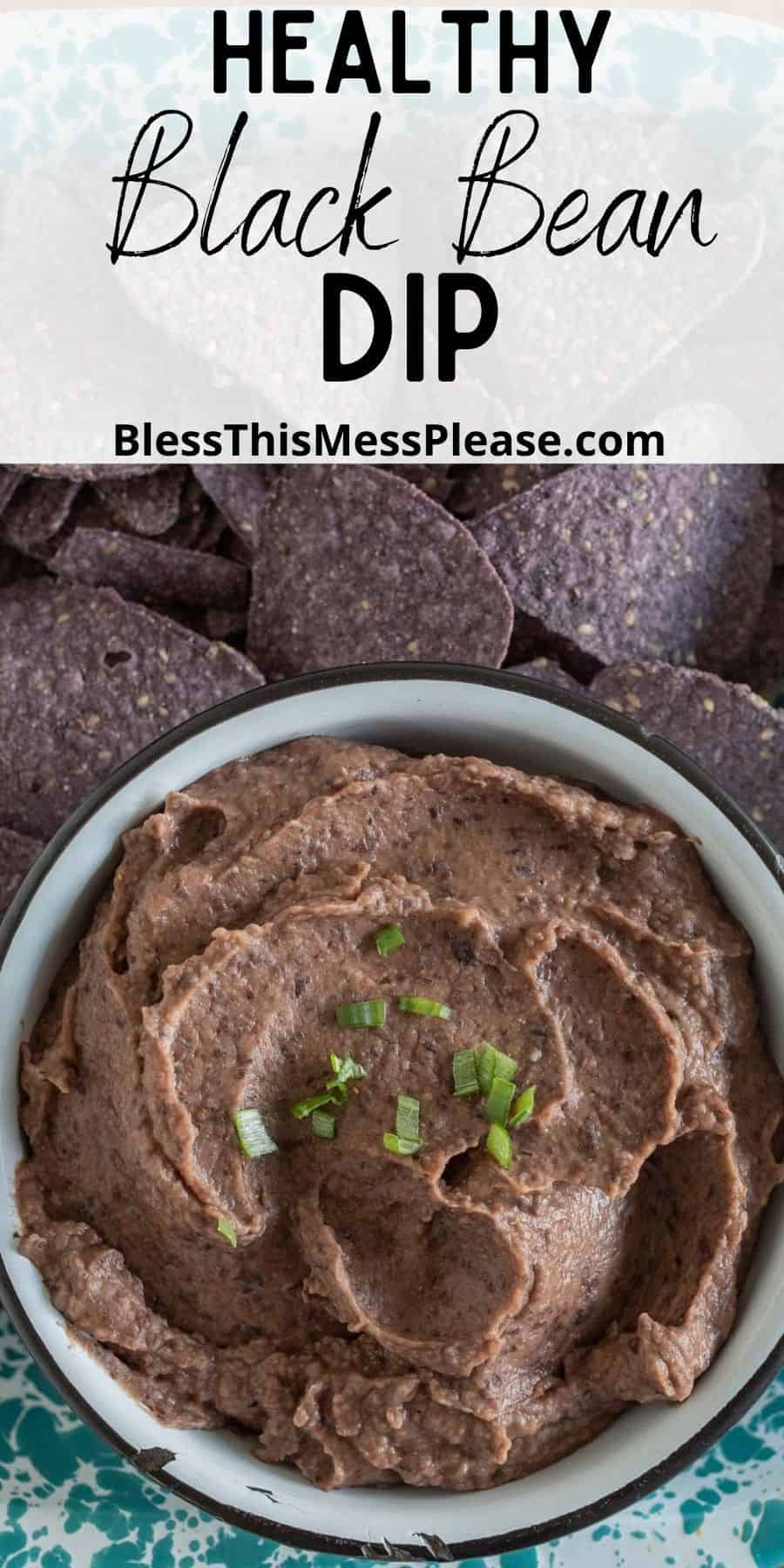 top view of a bowl of black bean dip next to a tray of tortilla chips with the words "healthy black bean dip"