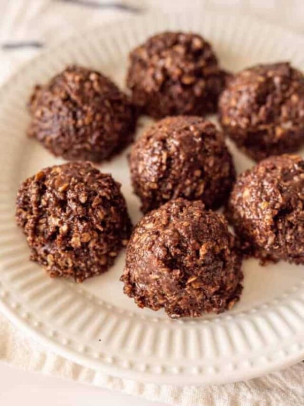 white plate with dark brown chocolate cookie balls