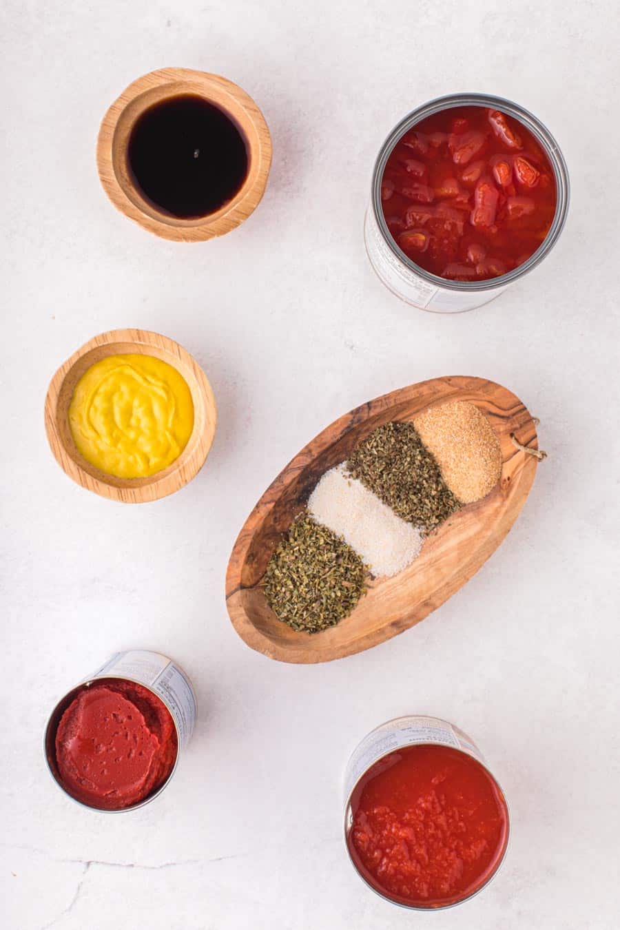 Top view of wooden boats of beautiful spices to make spaghetti sauce