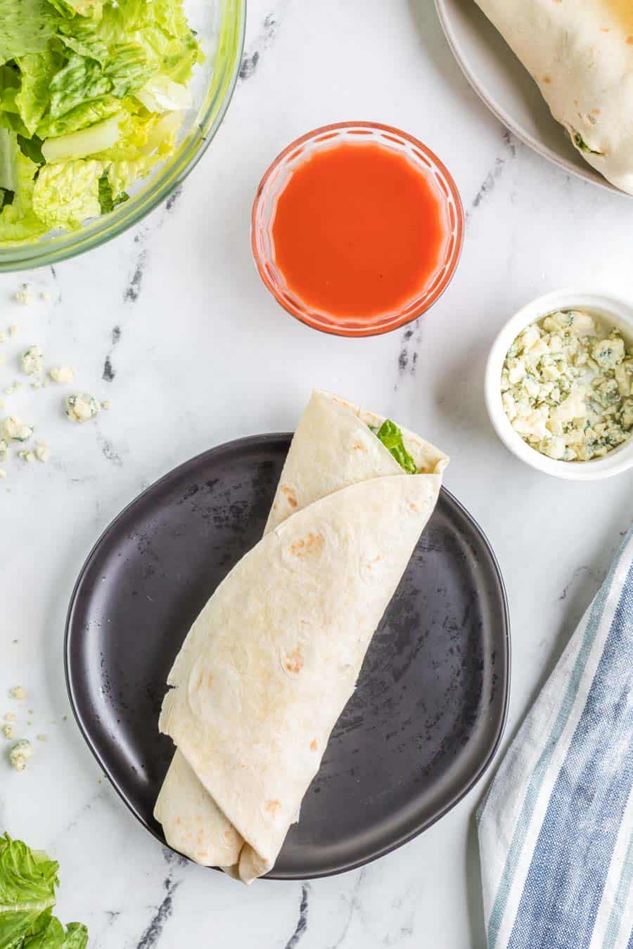 gently wrapped flour tortilla with lettuce and sauce