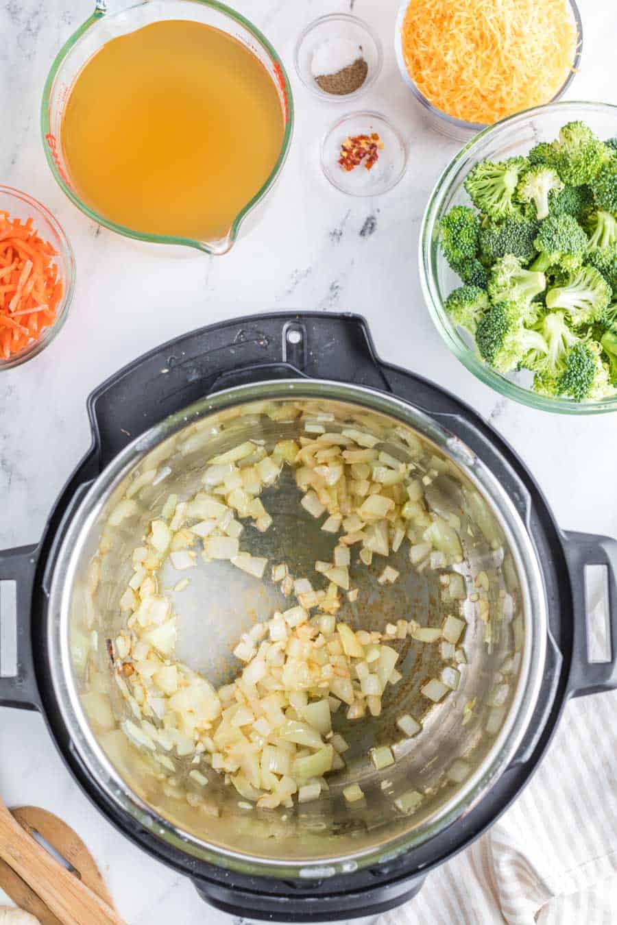 top view of an instant pot as onions and garlic are simmered down