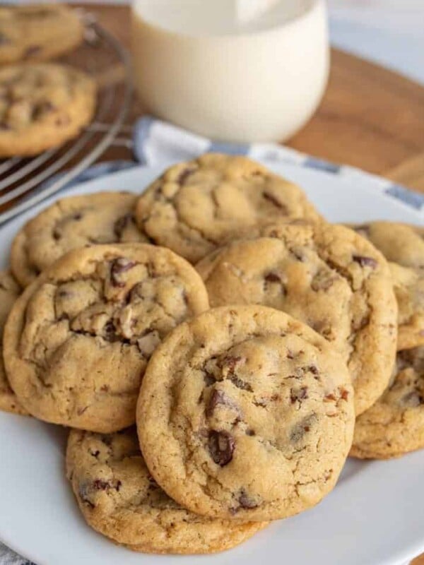 a plate stacked with chocolate chip cookies