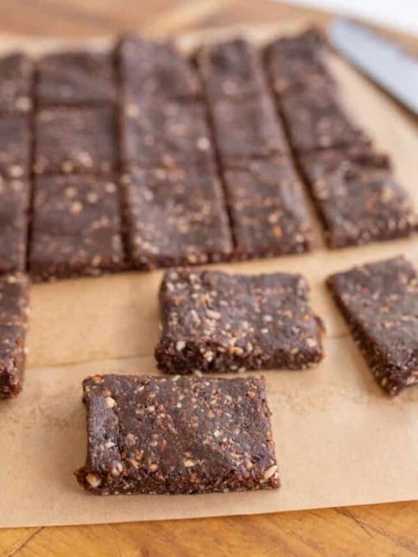 cutting squares out of the healthy date and nut snack bars on parchment