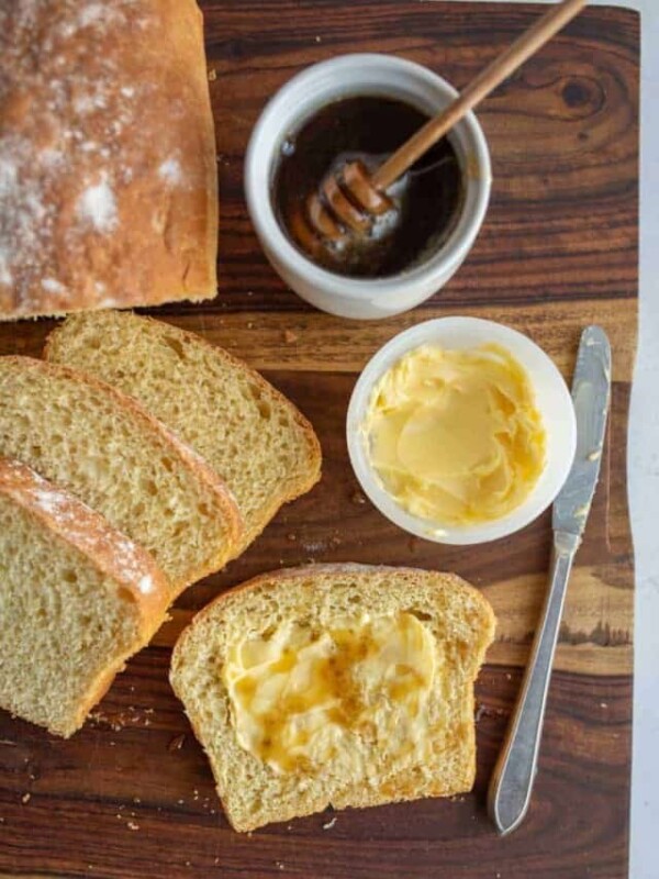 top view of butter and honey on sliced airy potato bread