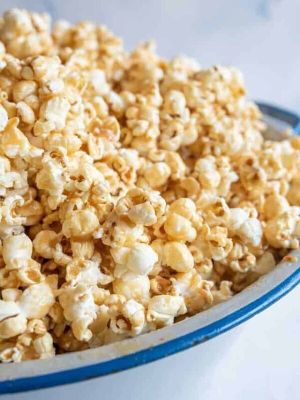 close up of soft caramel popcorn on a big white and blue bowl