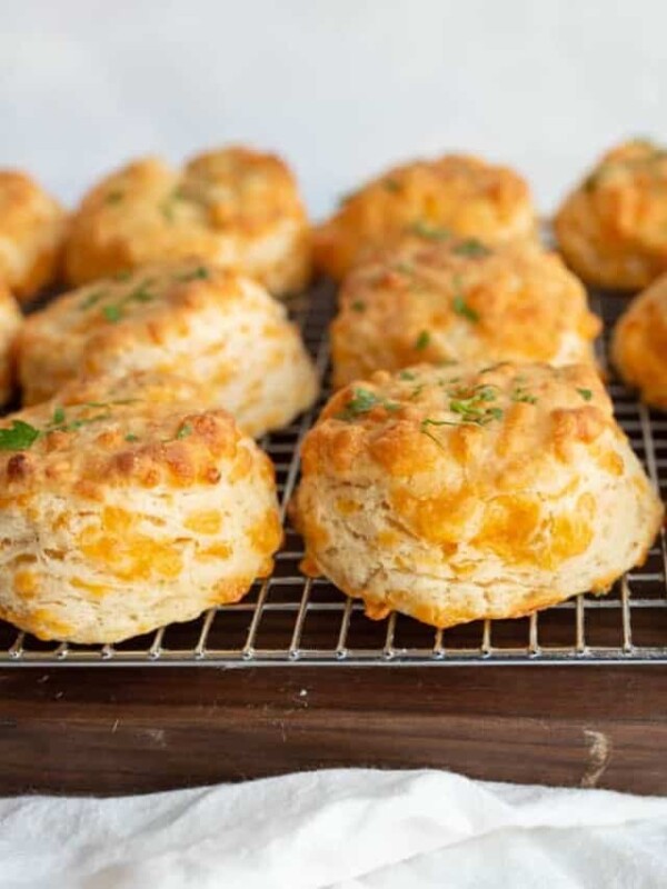 side view of cheddar biscuits on a cooling rack