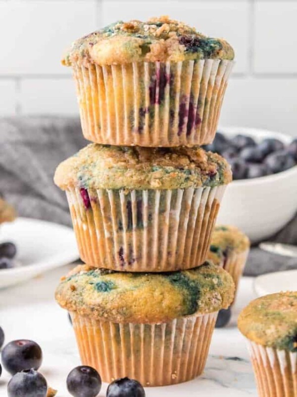 three homemade blueberry muffins stacked on top of each other