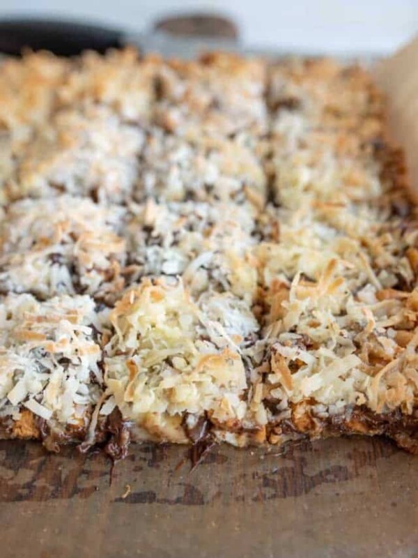 7 Layer Magic Bars being sliced from the whole baked sheet