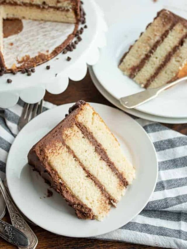 White Cake with chocolate icing with two servings wedged out onto white plates