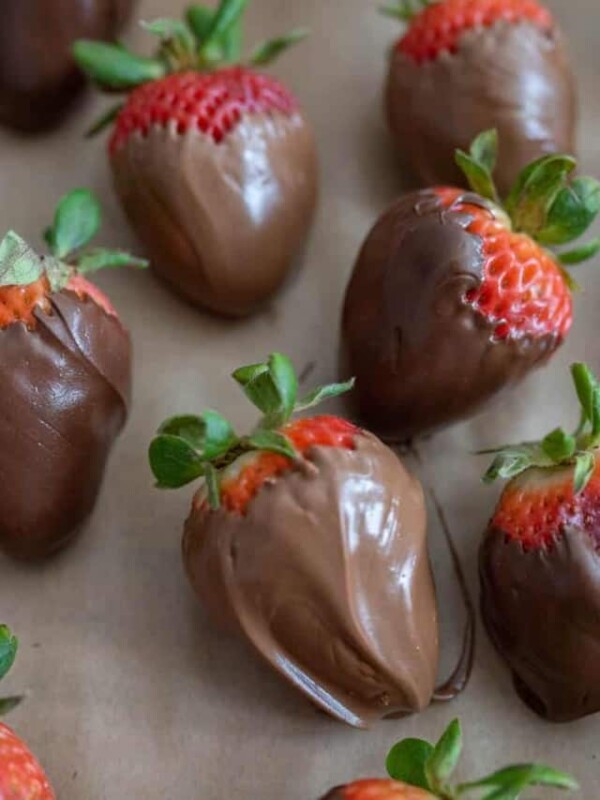 chocolate covered strawberries on parchment paper close up