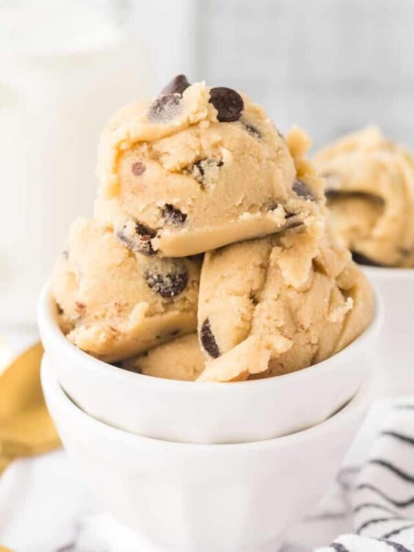 white bowls of round scoops of edible cookie dough