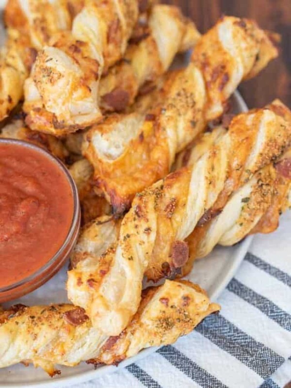 plate of pizza twists with marina dipping sauce in the middle