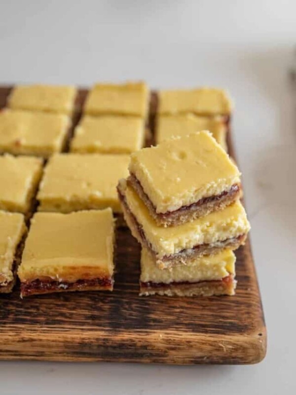 wooden board with raspberry cheesecake bars