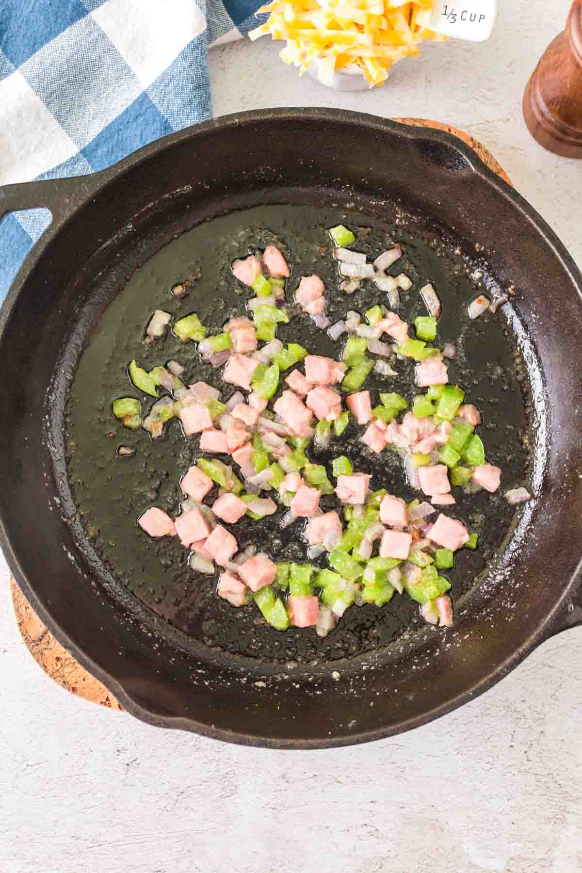 raw ingredients for a omelet being cooked on the cast iron.