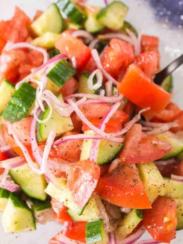 close up of cucumber tomato salad with onions and spices