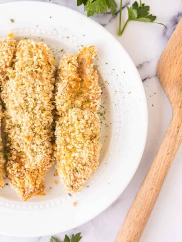 three baked chicken tenders on a white plate