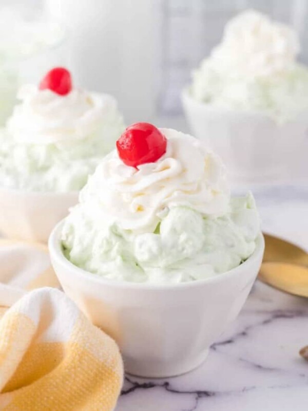 top view of pistachio jello salad topped with whipped cream and a cherry