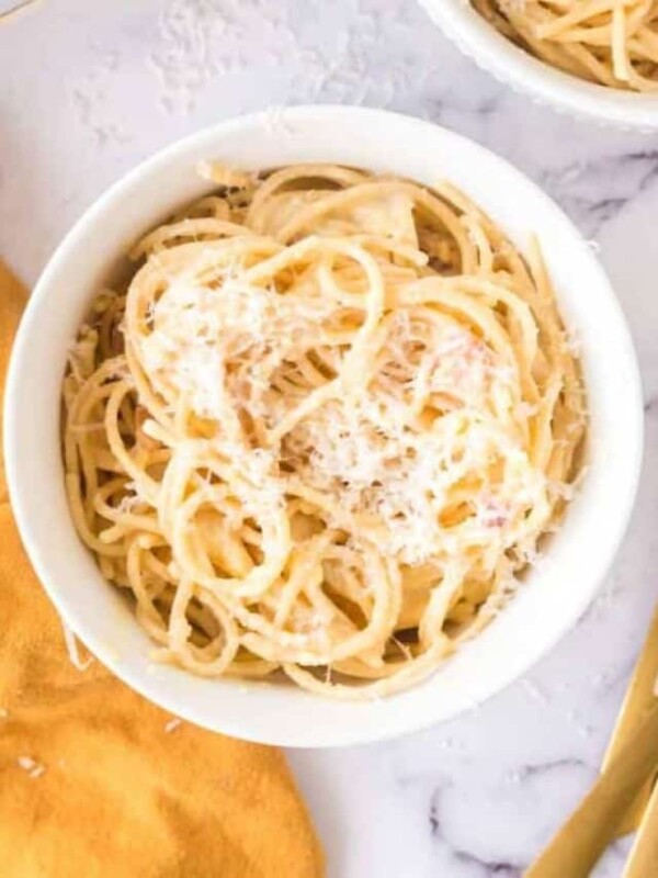 spaghetti carbonara in white bowls