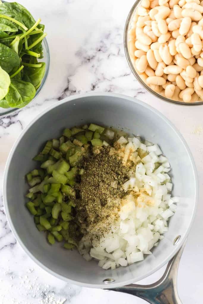 white bean soup ingredients in a sauce pan.