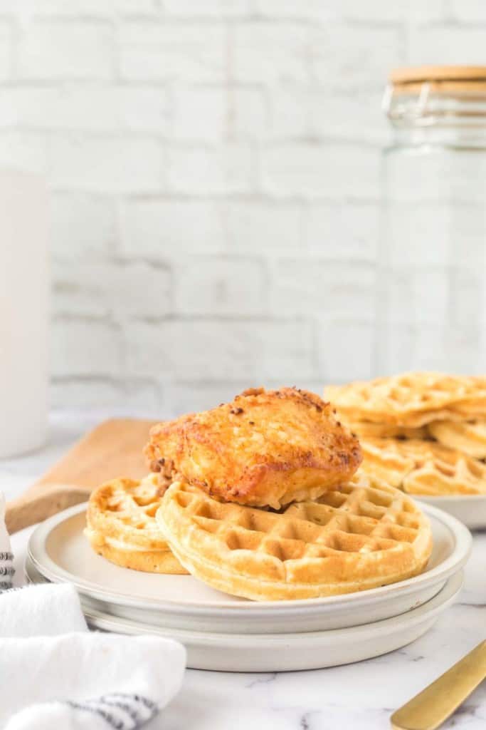 crispy chicken atop homemade waffles and maple syrup.