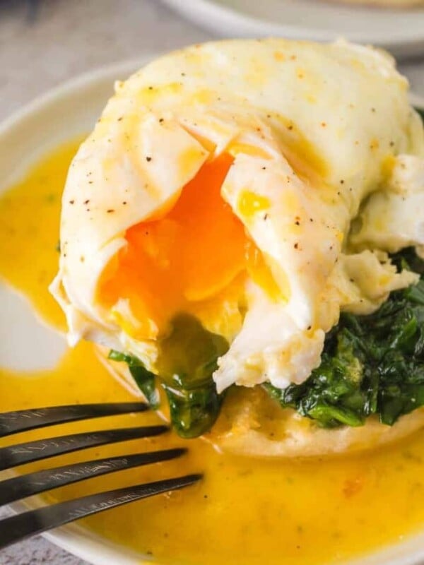 gooey poached egg atop spinach on an english muffin for eggs Florentine