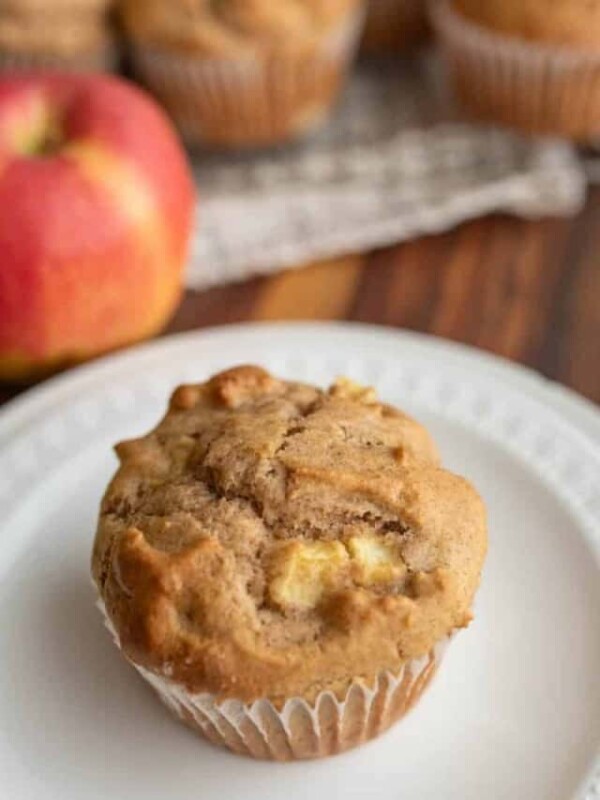 apple cinnamon muffin on a white plate.