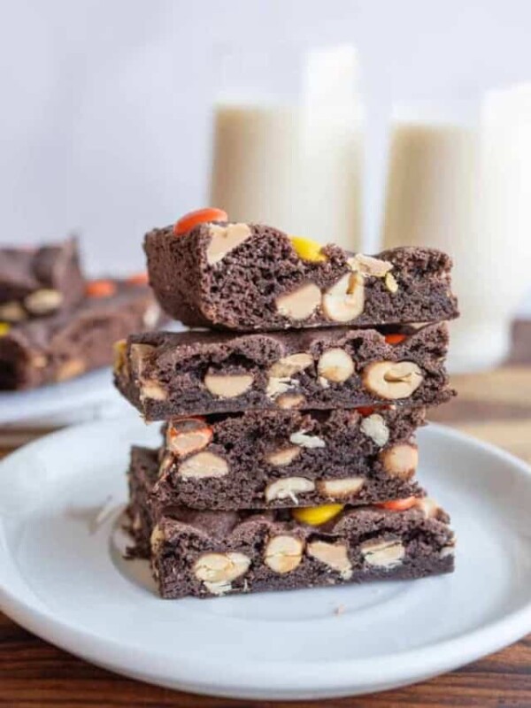 stack of cake bars with glasses of milk in the background