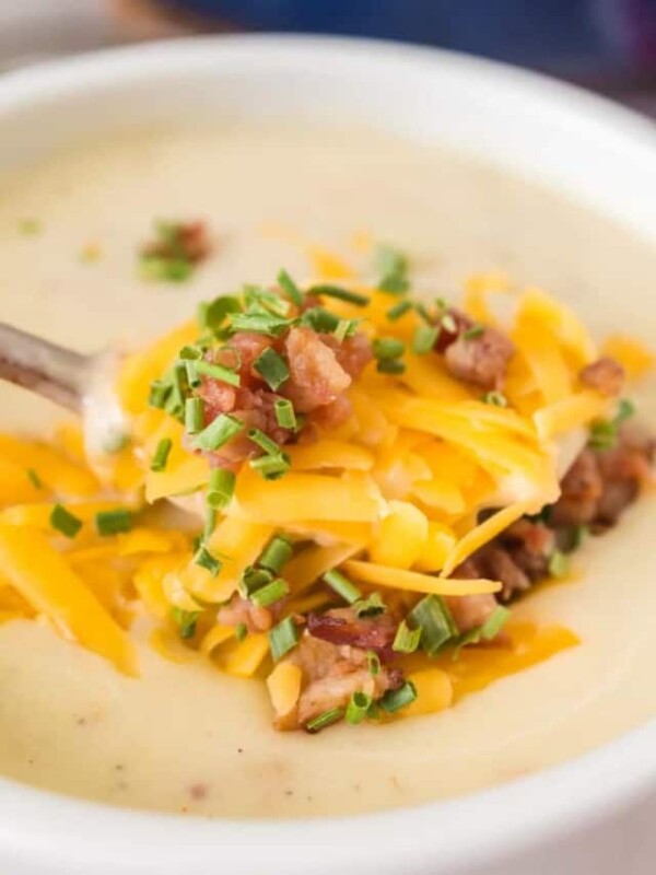 close up of cream of potato soup with cheese and bacon on top