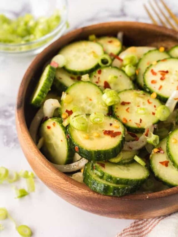 slices of cucumber and spices in a bowl for korean cucumber salad