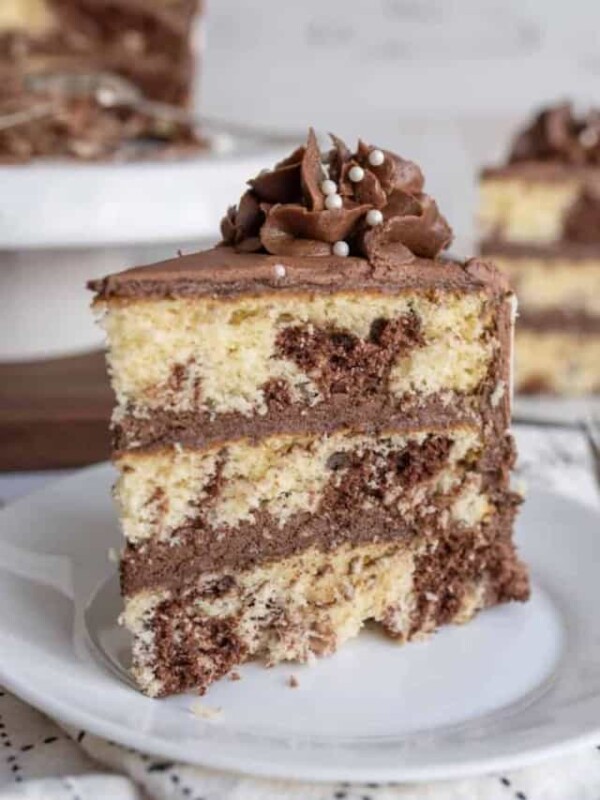 slice of three layered marble cake mixed with vanilla and chocolate cake