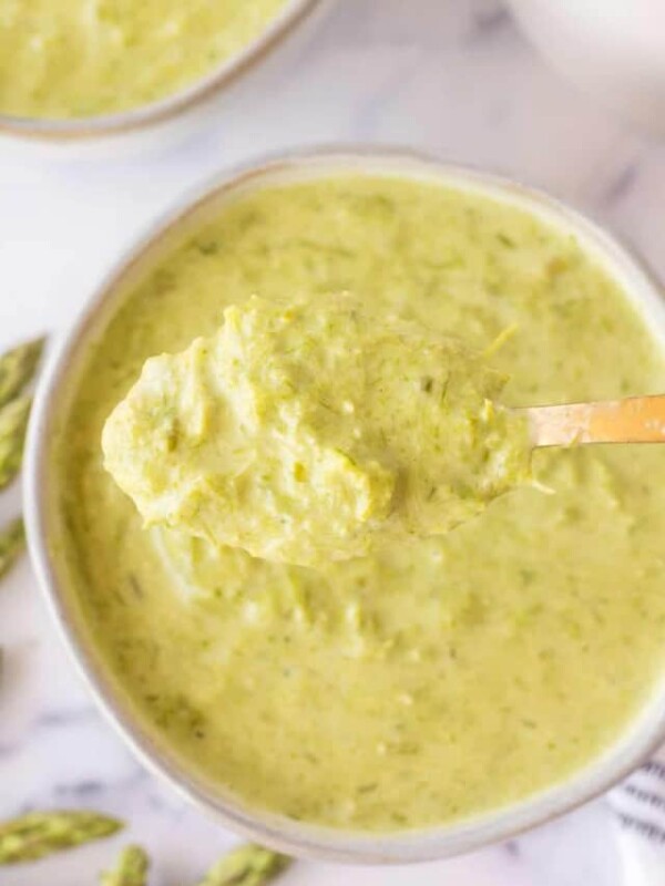 top view of a spoon full of asparagus soup