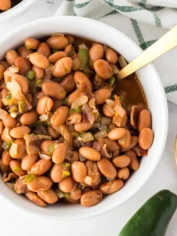 bowl of charro beans with a spoon