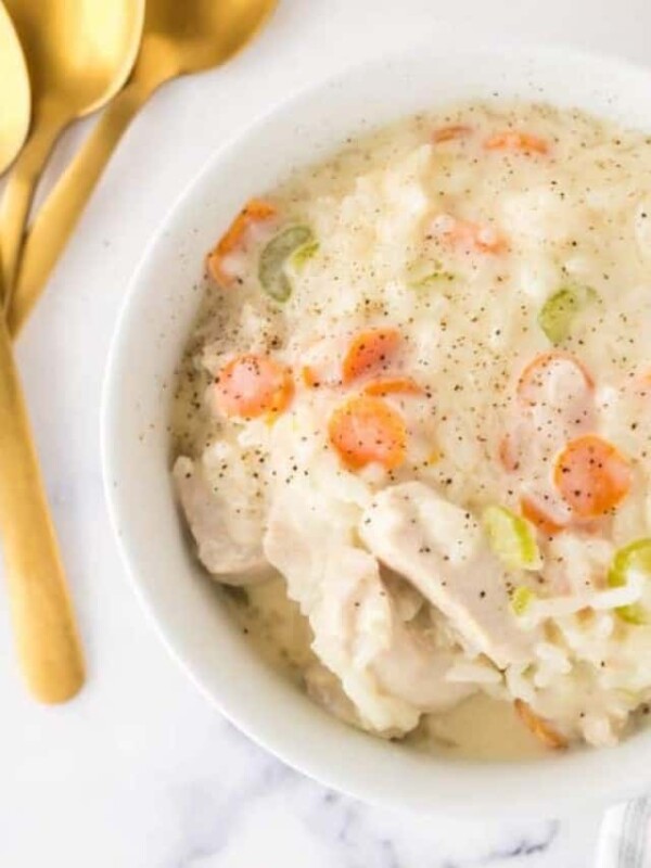 chicken and rice soup in a white serving bowl