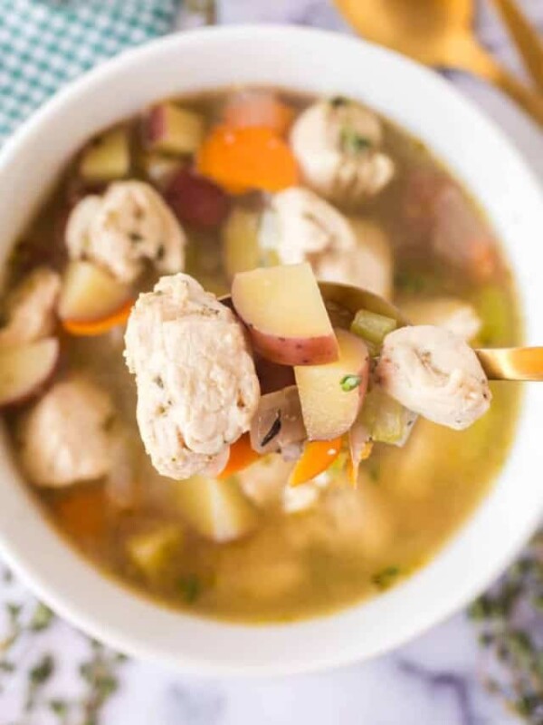 chicken stew on a spoon over a bowl