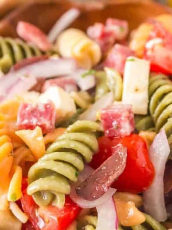 close up of Italian pasta salad in a wooden bowl.