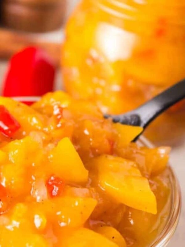 mango chutney in a small glass bowl and a spoon