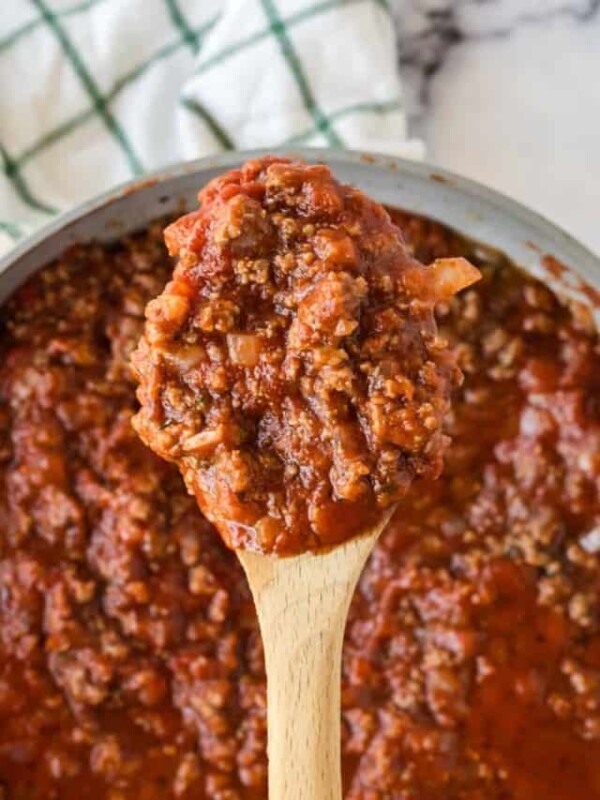 homemade meat sauce on a wooden spoon