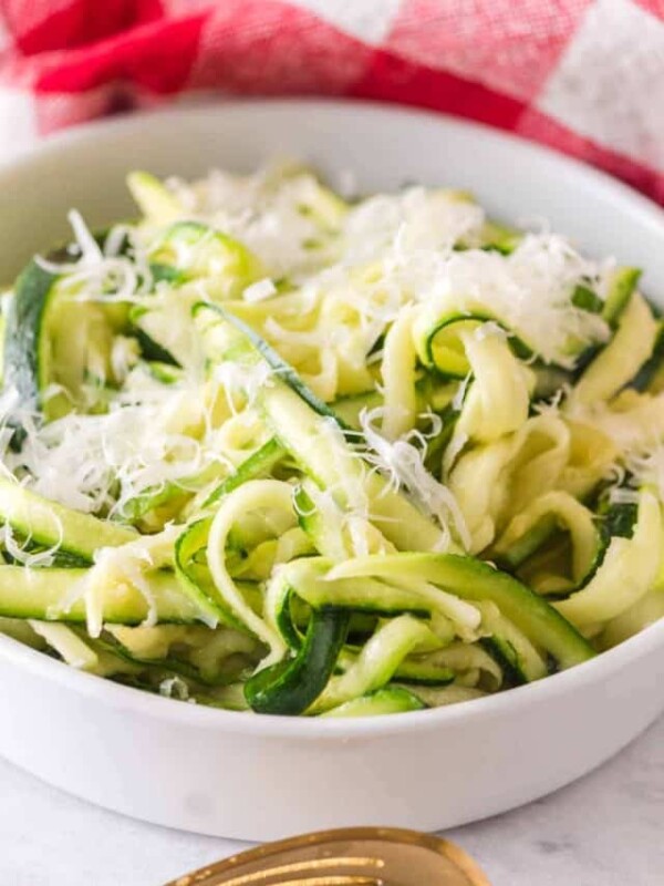 bowl of fresh zucchini noodles with parmesan on top