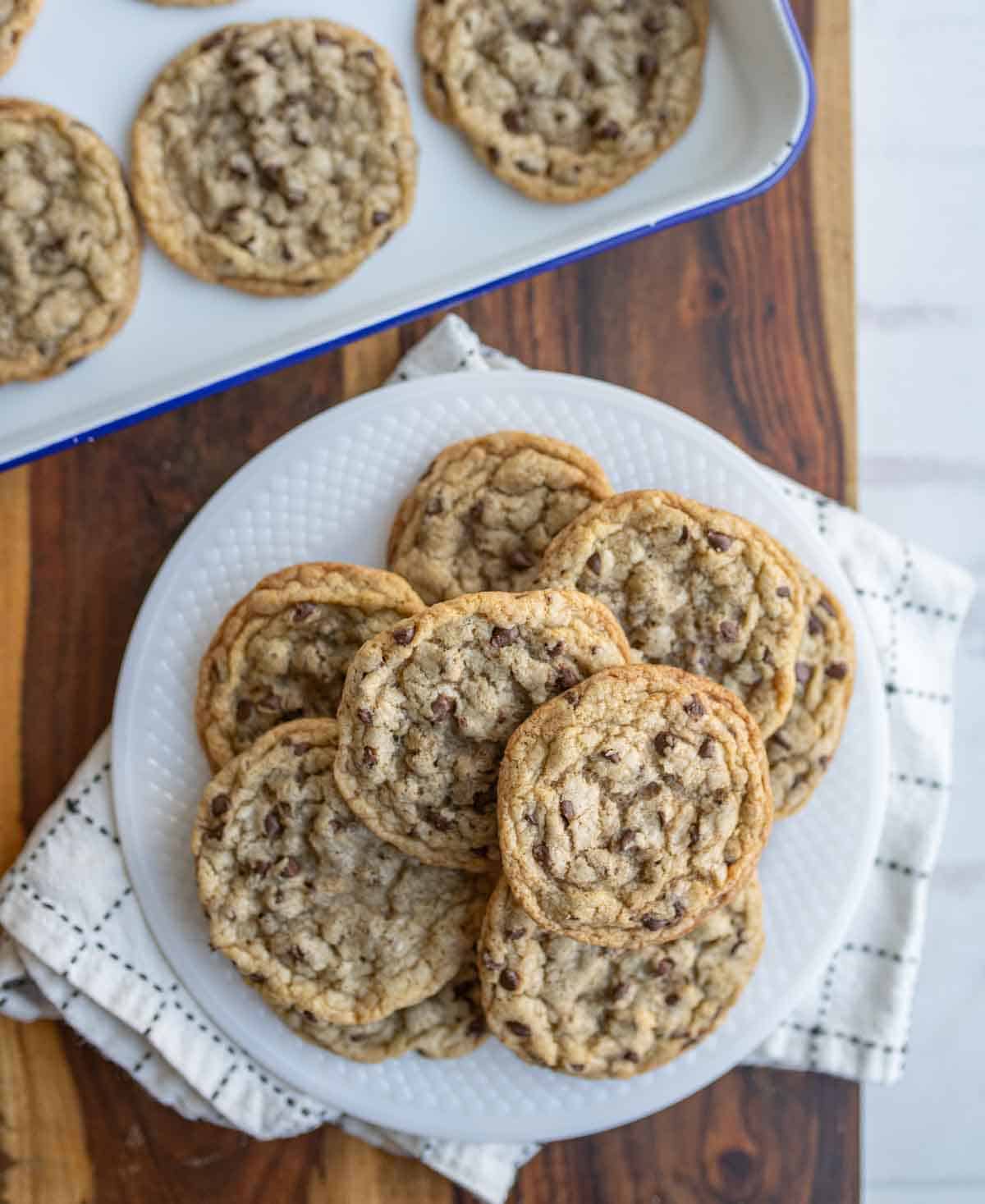 top view brown butter chocolate chip cookies stacked on a plate.