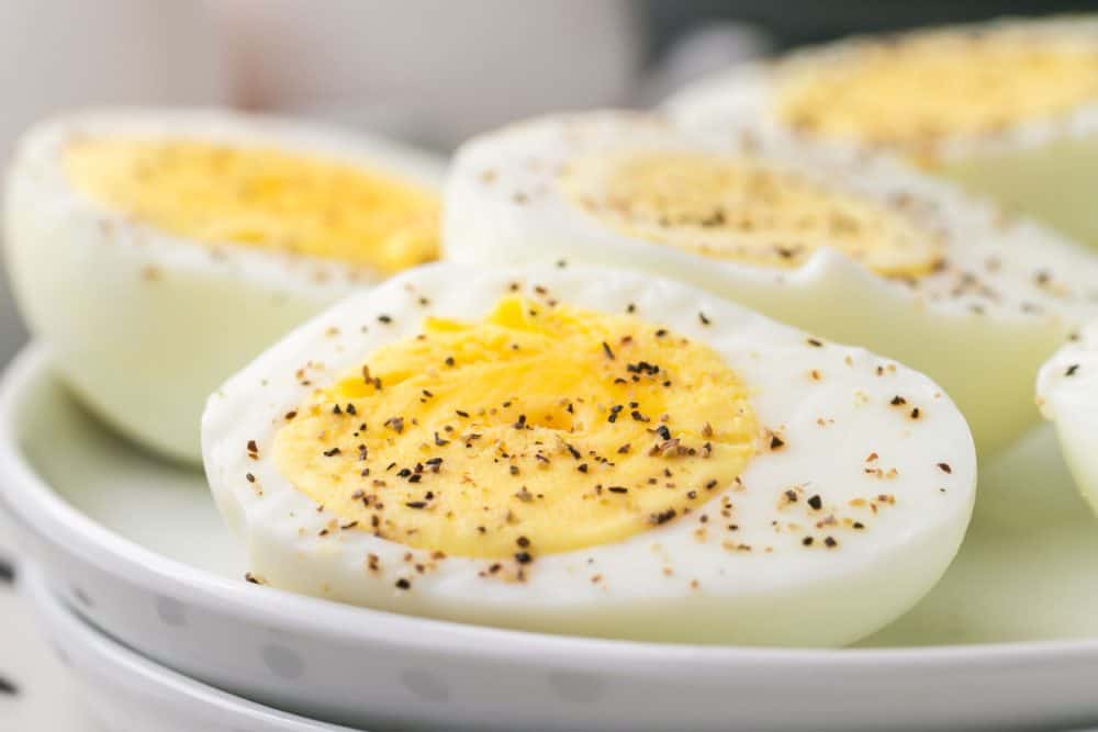 extra close up of an air fryer hard boiled egg sliced in half and seasoned