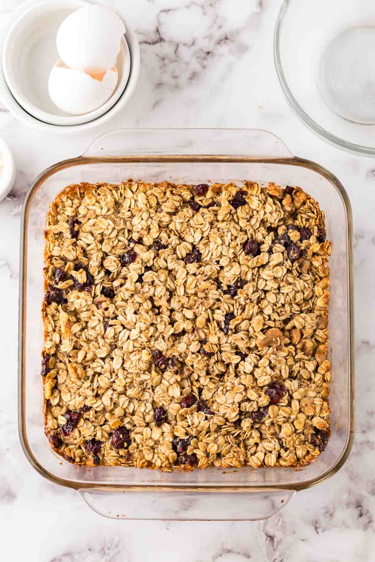 breakfast bars baked into a square clear glass dish.