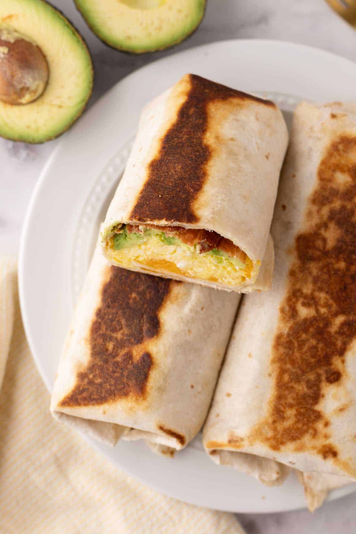 Grilled breakfast burrito cut in half.