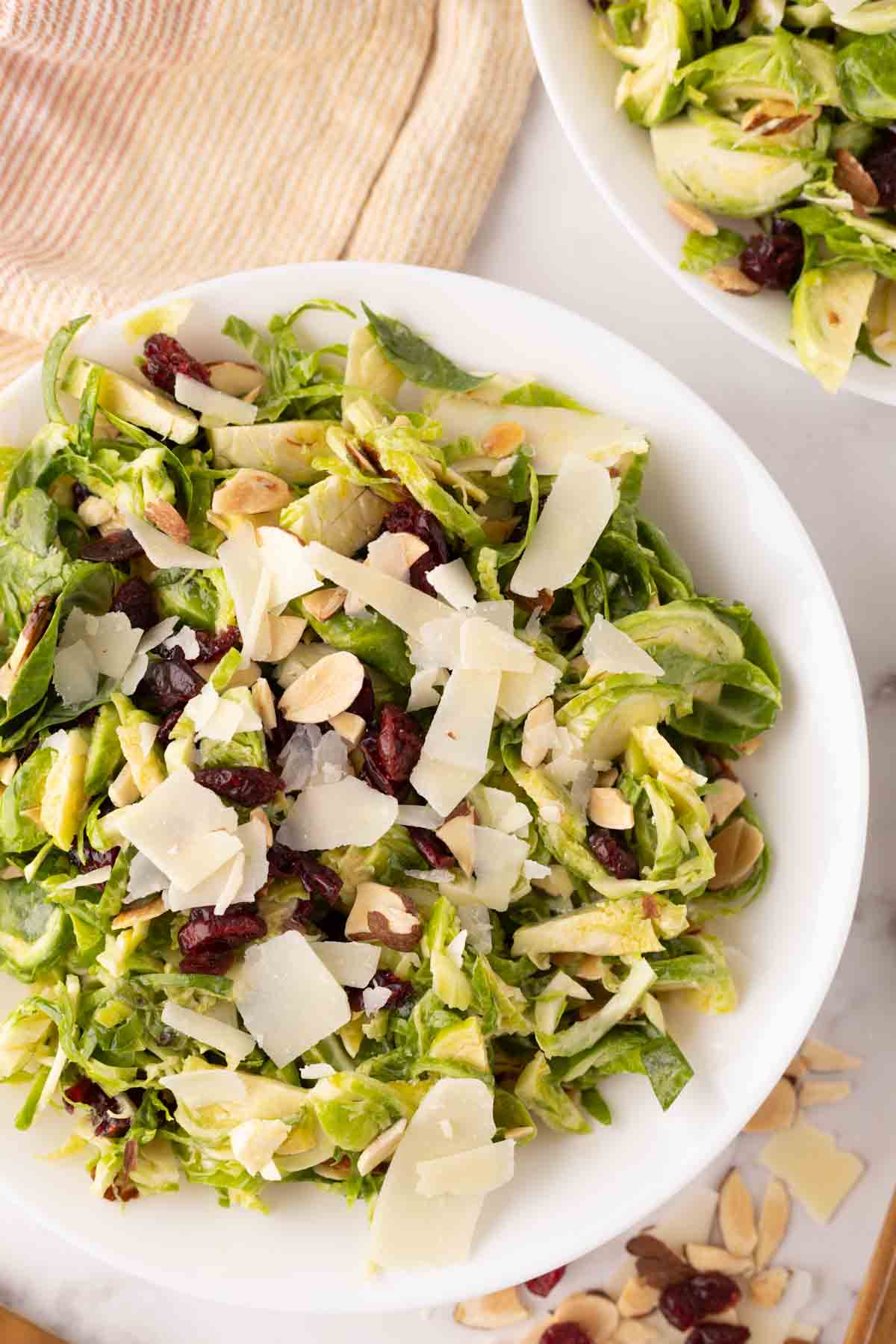 Brussels sprouts salad on white plates.