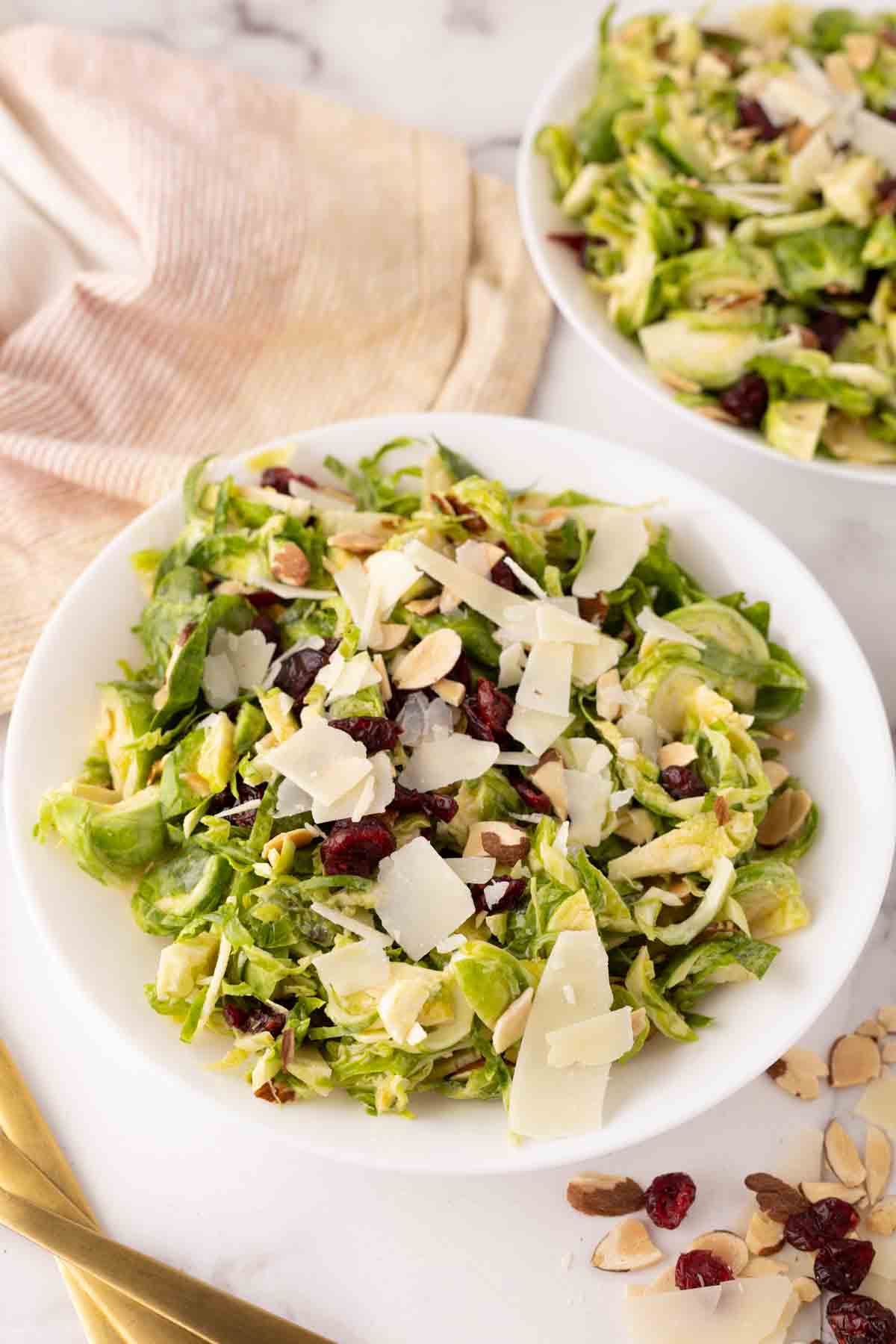 Brussels sprouts salad on white plates.