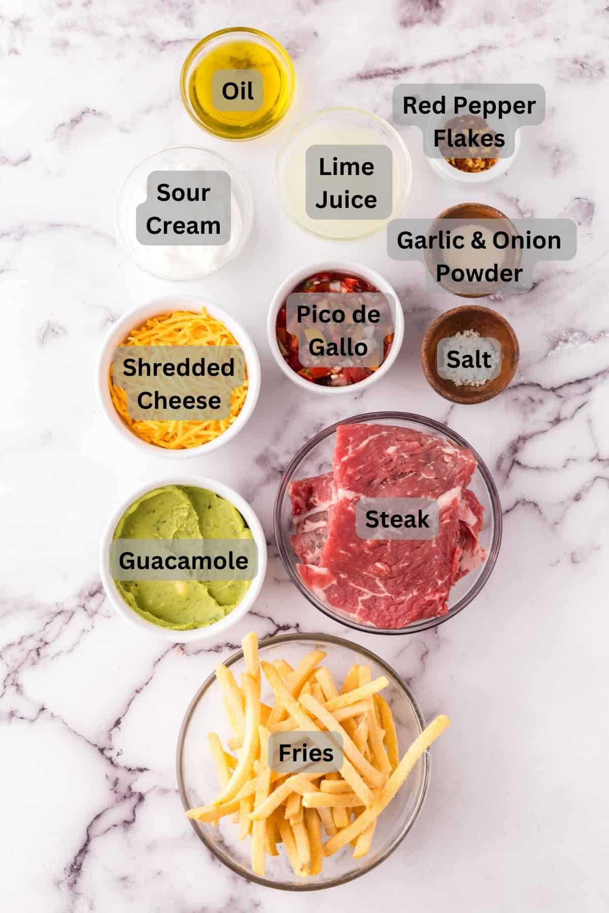 portion bowls each with digitally labeled raw ingredients to make carne asada fries.