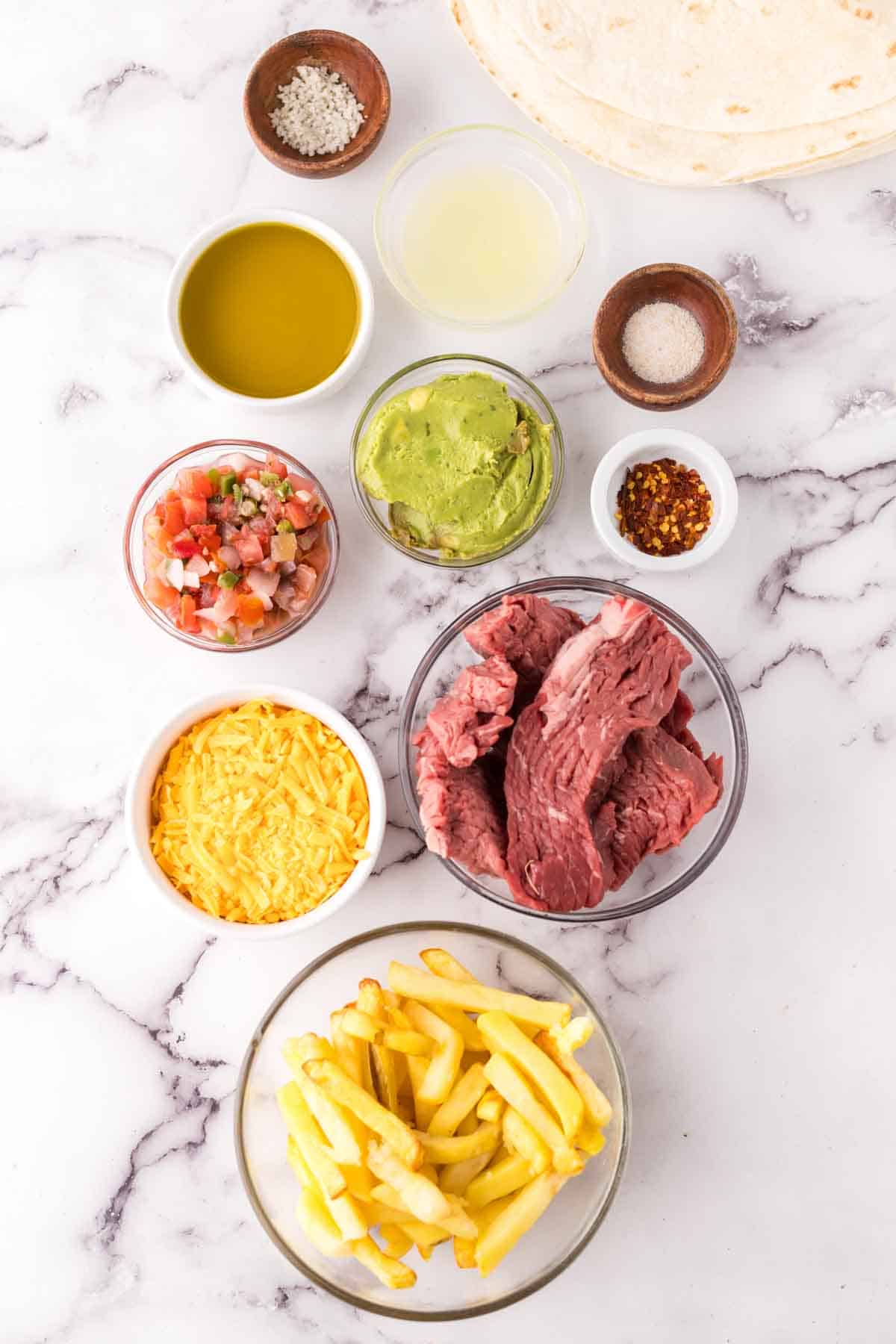 portion bowls each with raw ingredients to make California burritos.