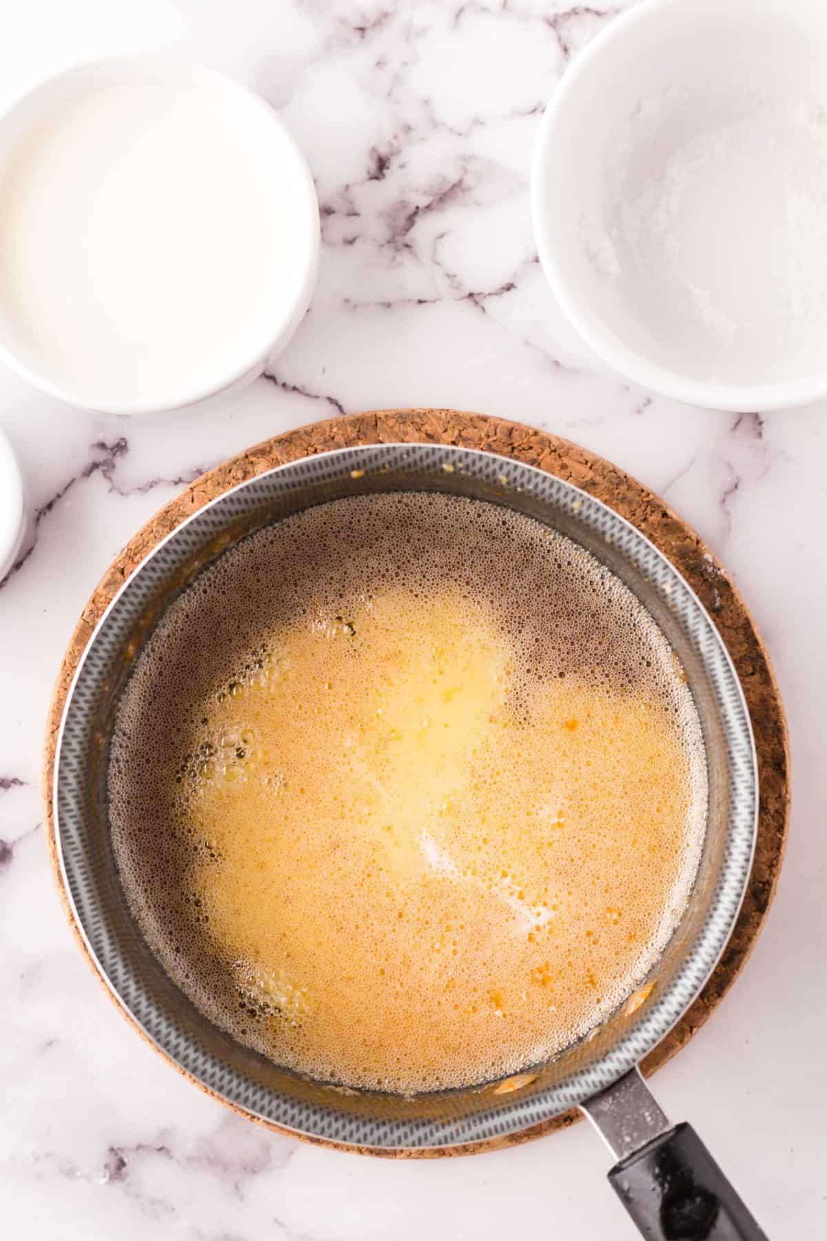 sauce pan with ingredients to make homemade caramel sauce.