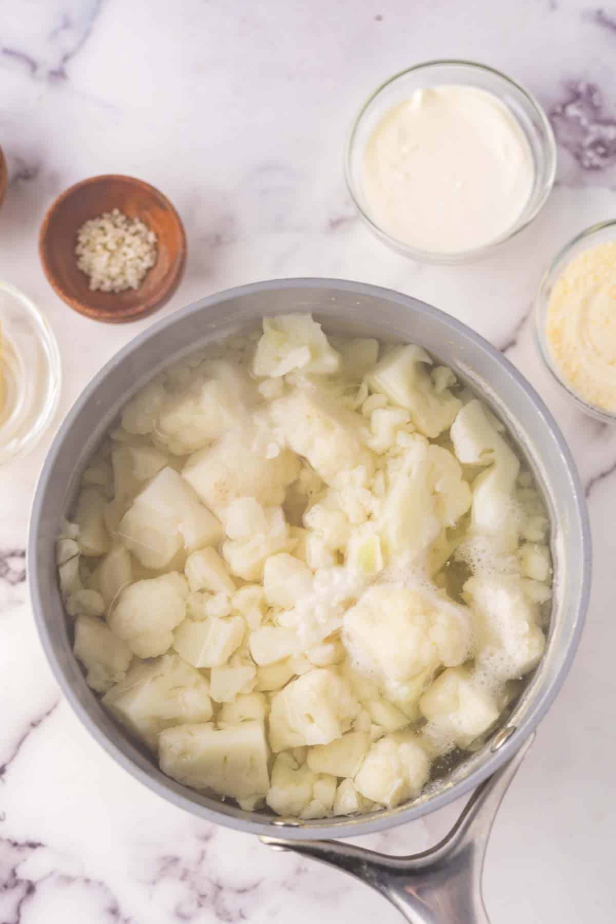 sauce pan with the process making cauliflower mashed potatoes recipe.