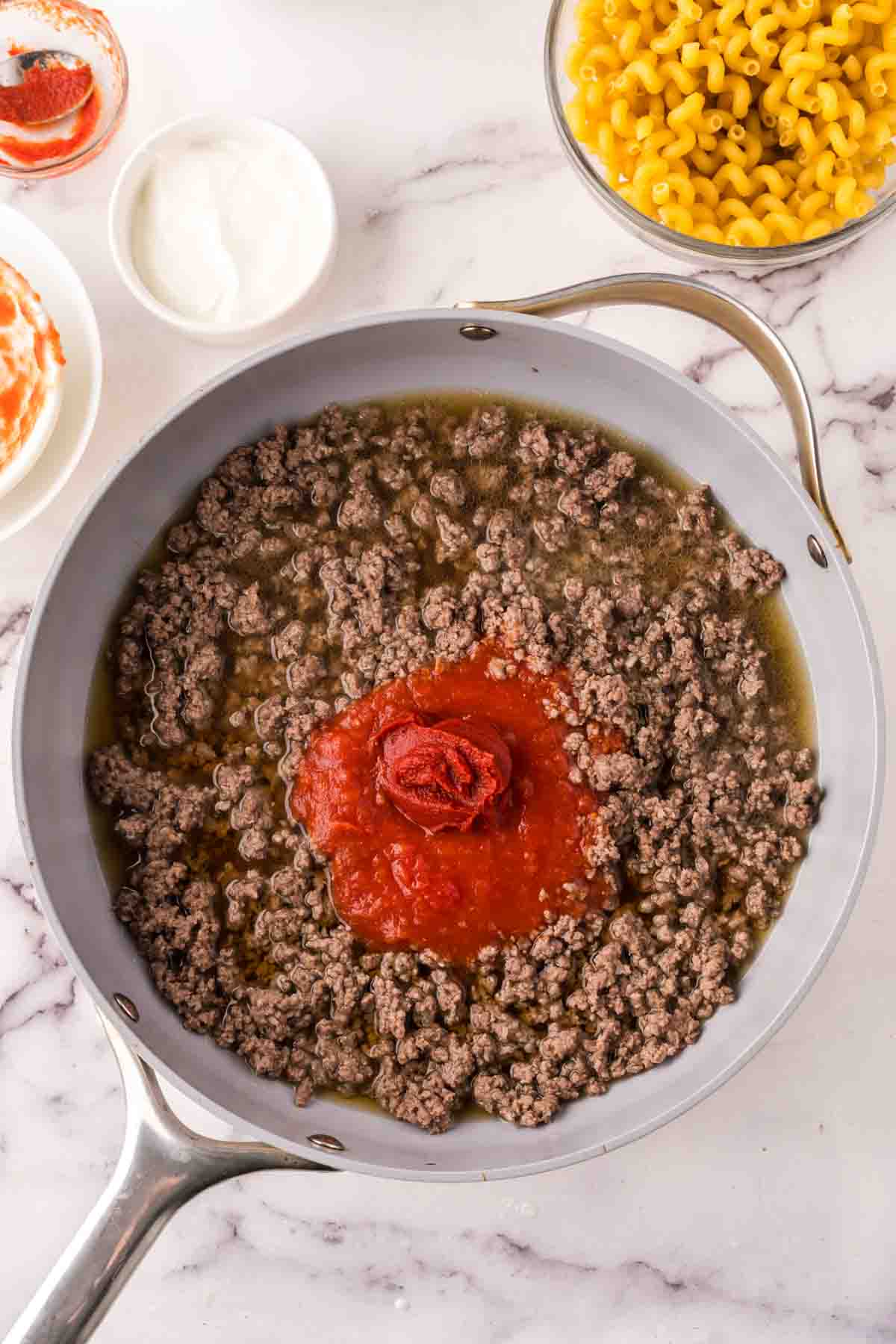 sauce pan with the progress of cheeseburger casserole recipe.