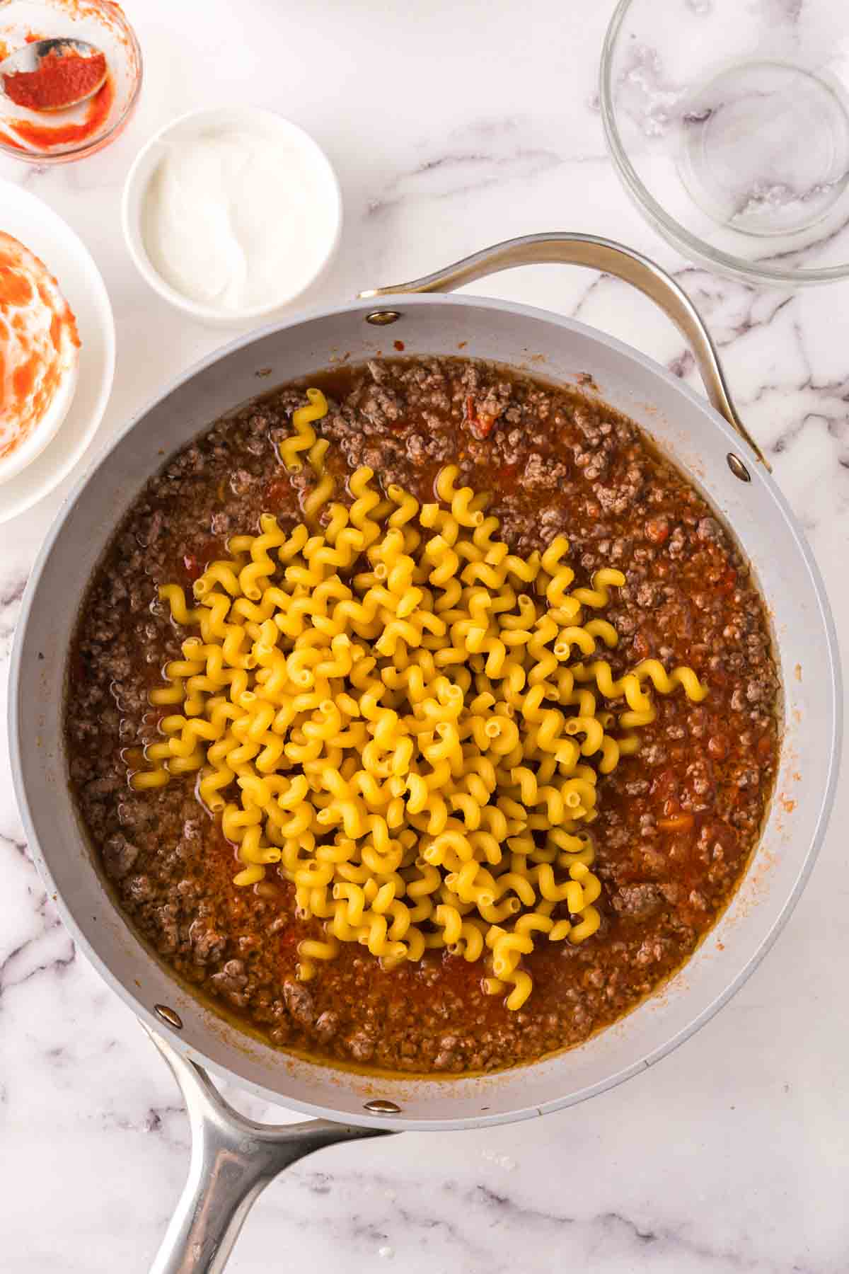 sauce pan with the progress of cheeseburger casserole recipe.